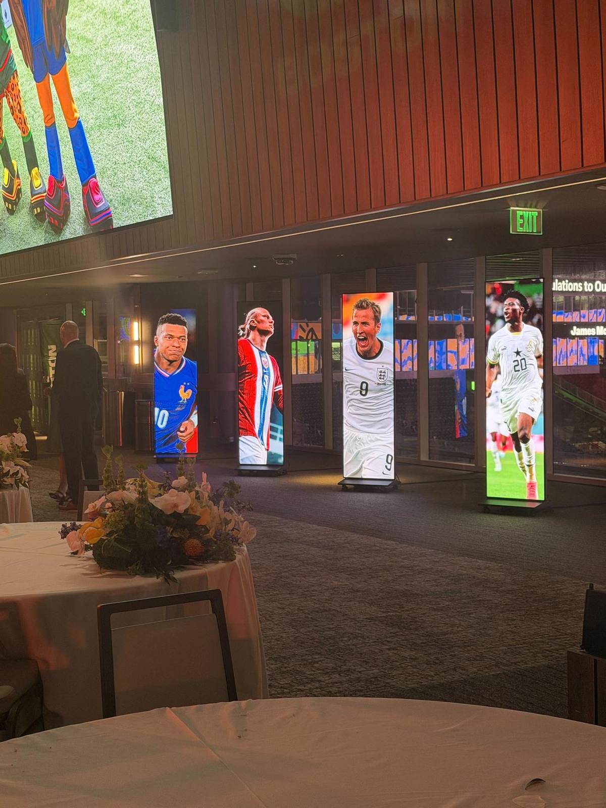 Four freestanding LED totems in a stadium hospitality space